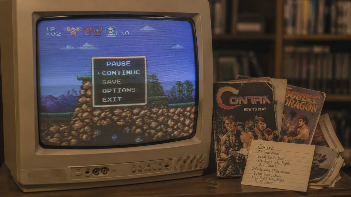 CRT television with classic game pause screen and old manuals